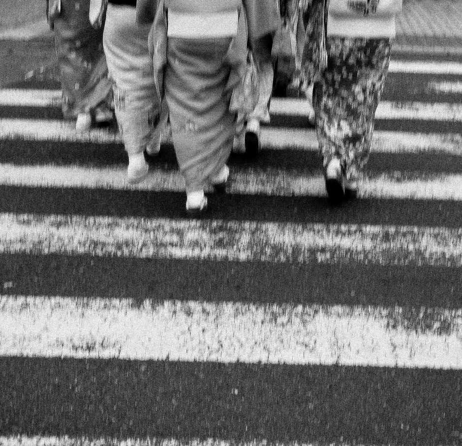 A group of geisha women cross the street in Kyoto